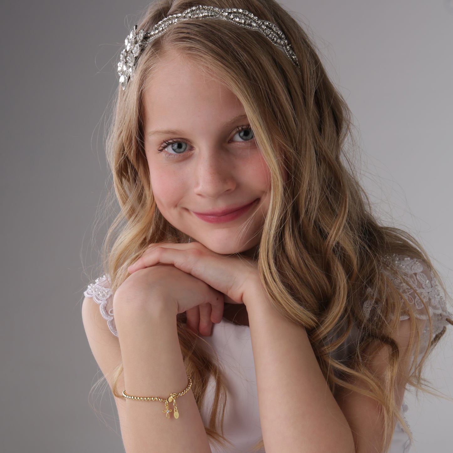 girl wearing 14K Gold Plated Cross Bracelet for Baby Baptism and First Communion Gifts - Cherished Moments Jewelry